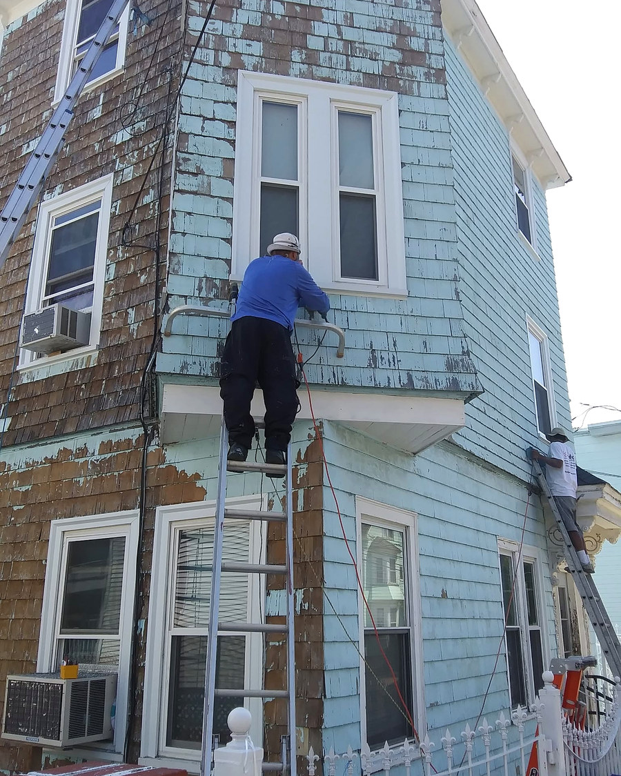 Boston Brush Works painter scraping an exterior down to sound wood before priming